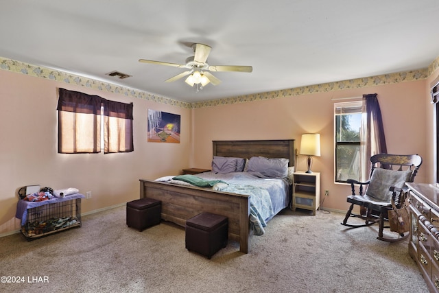 bedroom featuring light colored carpet and ceiling fan