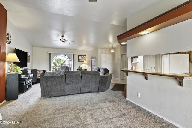 carpeted living room featuring ceiling fan