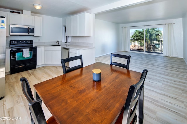 dining space featuring light wood finished floors