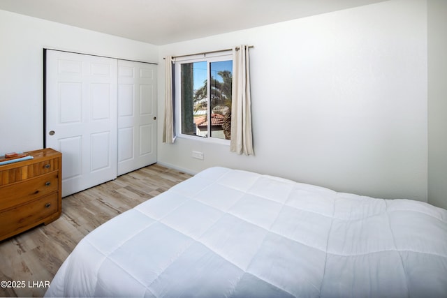 bedroom with a closet and wood finished floors