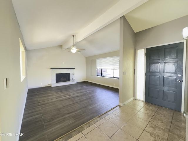 151 Viscount Ln, Lake Havasu City, AZ 86403 - unfurnished living room with wood finished floors, a ceiling fan, baseboards, a premium fireplace, and lofted ceiling with beams