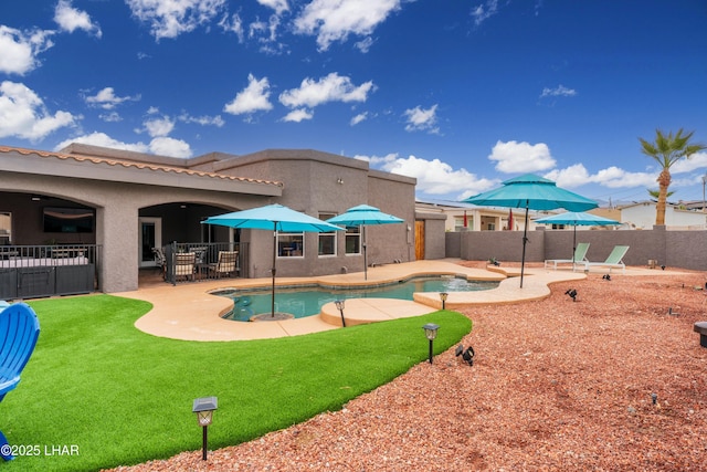 view of swimming pool featuring a patio area, a fenced in pool, and a fenced backyard