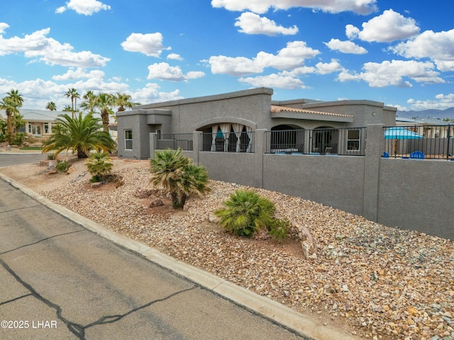 view of front of house with a fenced front yard and stucco siding