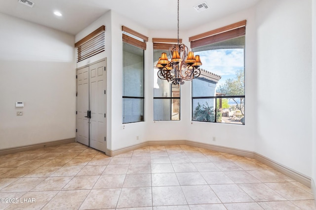 unfurnished dining area with baseboards, light tile patterned flooring, a chandelier, and visible vents
