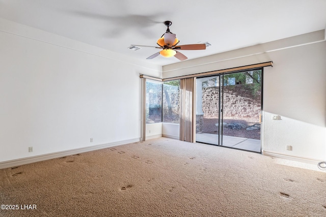 spare room featuring baseboards, visible vents, carpet floors, and ceiling fan