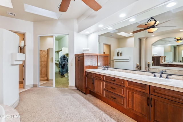 full bath with recessed lighting, visible vents, a ceiling fan, a sink, and a skylight