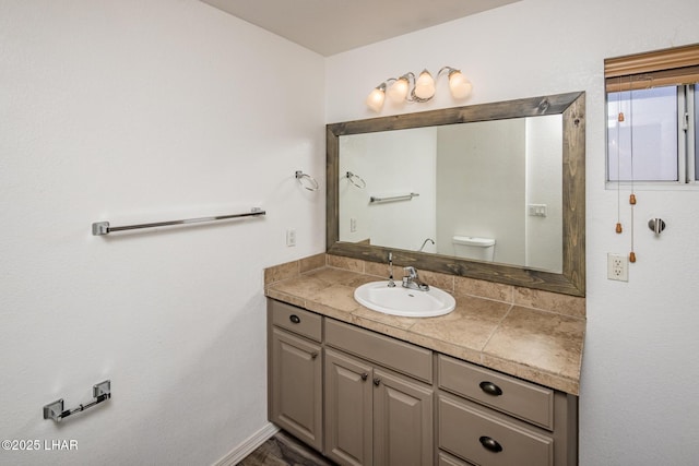 bathroom featuring vanity and toilet