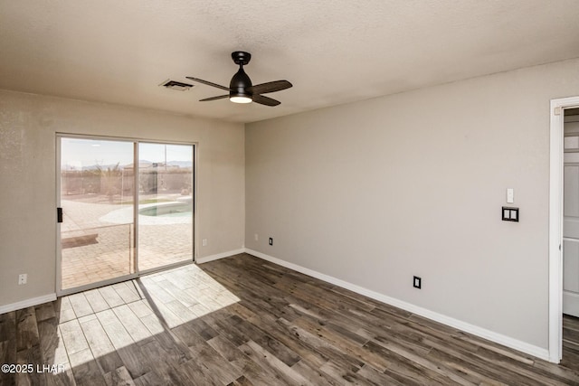 spare room with ceiling fan, dark hardwood / wood-style floors, and a textured ceiling