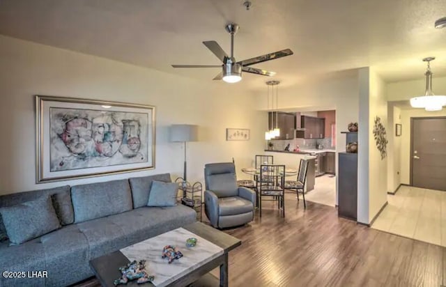 living room with ceiling fan and wood finished floors