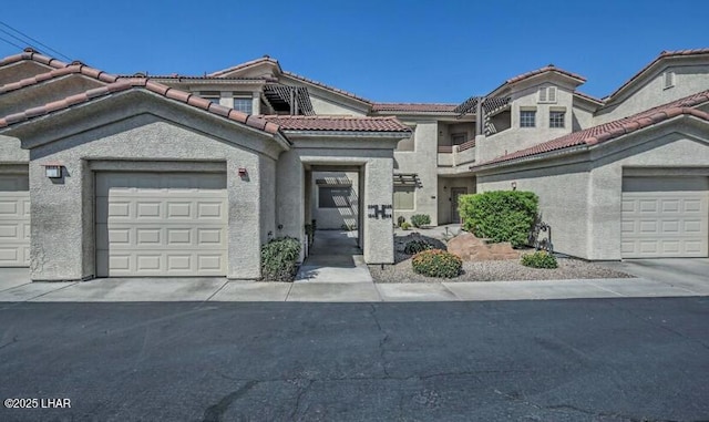 mediterranean / spanish-style home with a tile roof and stucco siding