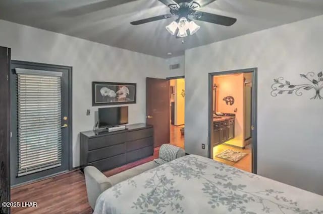 bedroom with visible vents, a ceiling fan, and wood finished floors