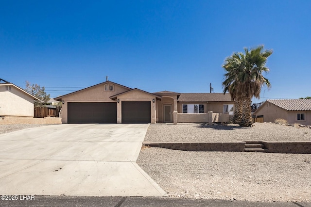 ranch-style house with fence, a garage, stucco siding, and concrete driveway