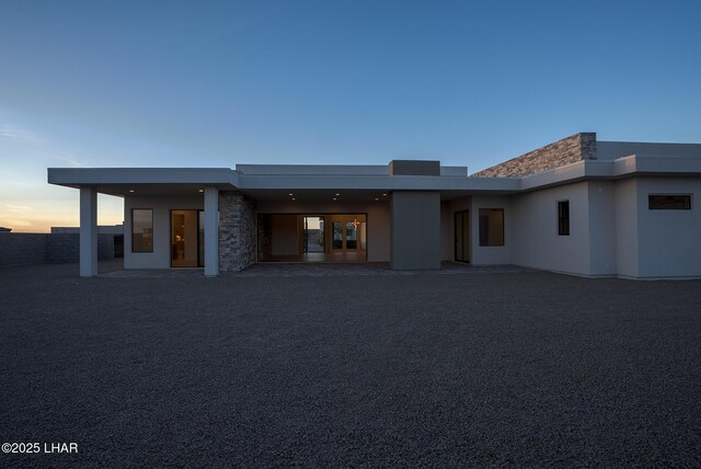 back house at dusk with a patio