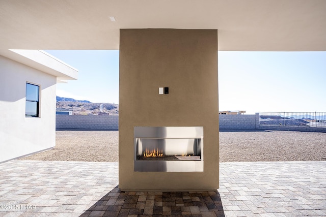 view of patio / terrace featuring a mountain view and a fireplace