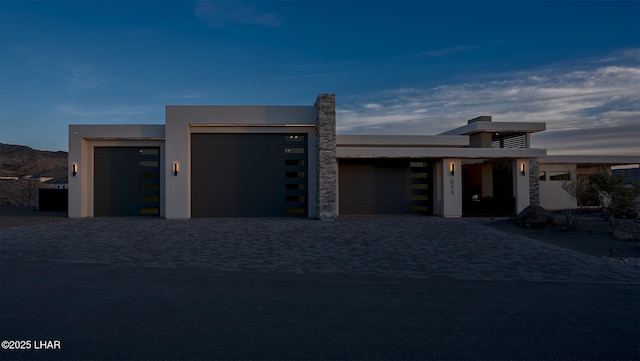 contemporary house with a mountain view and a garage