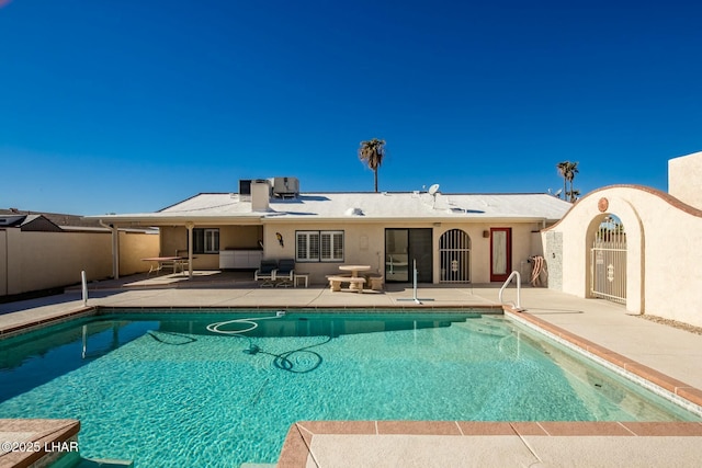 view of swimming pool with cooling unit and a patio area