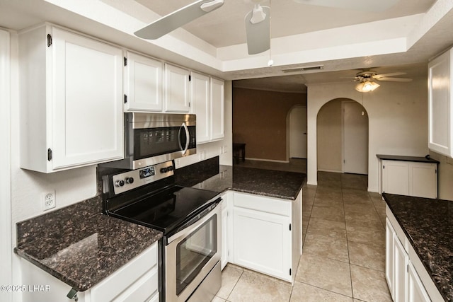 kitchen featuring stainless steel appliances, white cabinets, and ceiling fan