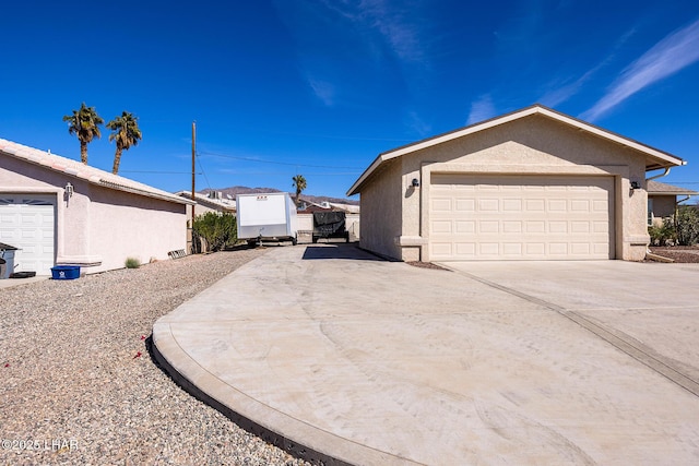 view of side of property with driveway and stucco siding