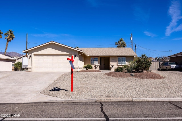 single story home with driveway, a garage, and stucco siding