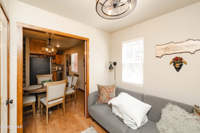 interior space with a chandelier and light wood-style flooring
