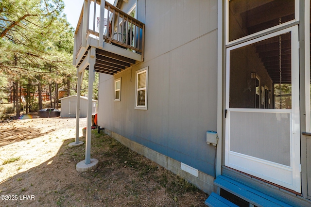 view of side of property featuring a storage shed, an outbuilding, and crawl space