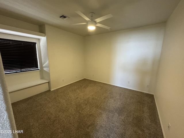 carpeted spare room with ceiling fan