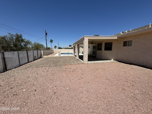 view of yard featuring ceiling fan and a patio area