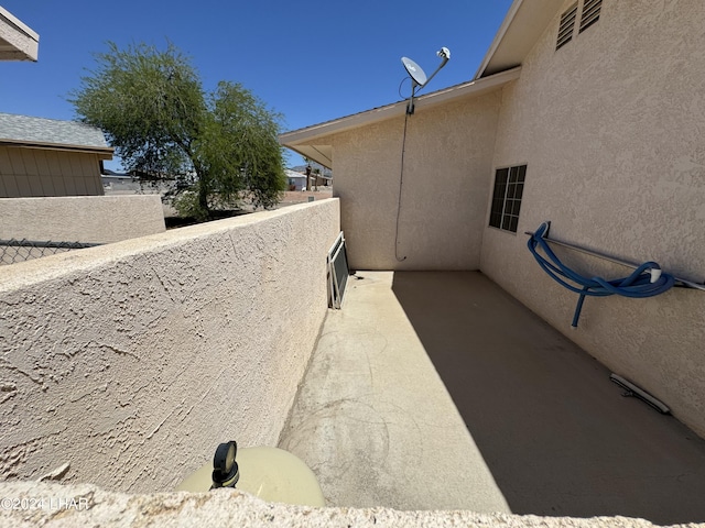 view of side of home featuring a balcony