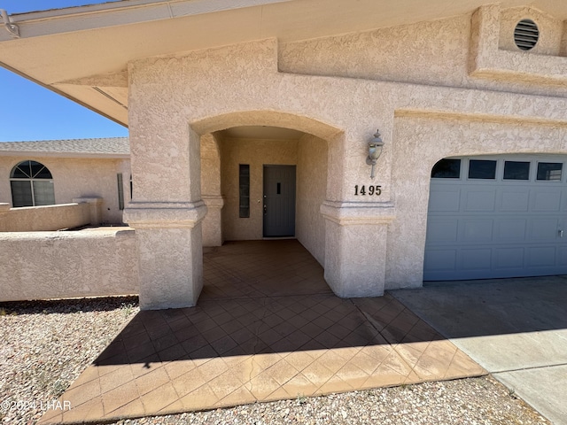 view of exterior entry with a garage