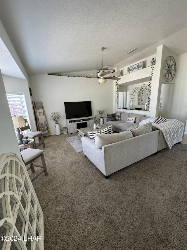 living room with dark colored carpet, ceiling fan, and a textured ceiling