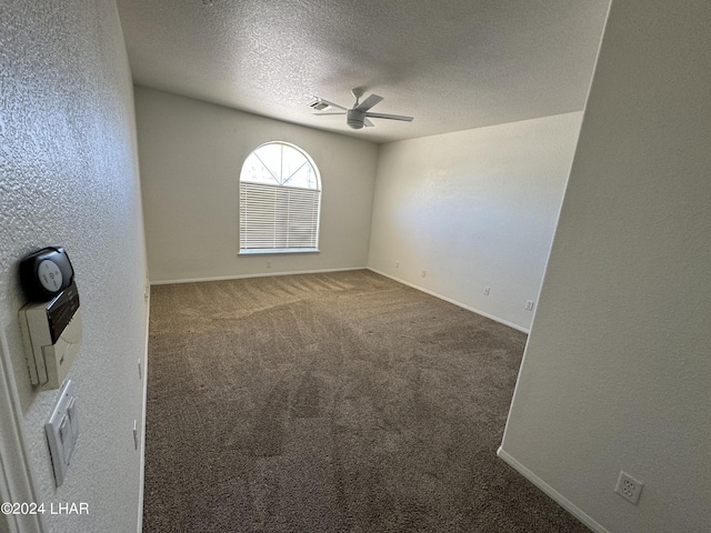 empty room with carpet, a textured ceiling, and ceiling fan