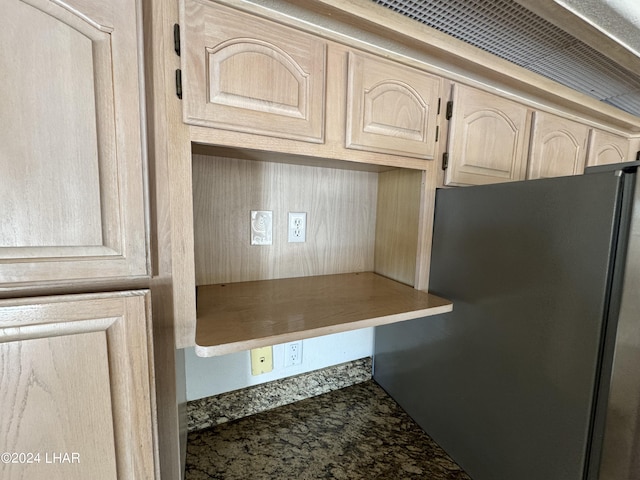 kitchen featuring stainless steel fridge and light brown cabinetry