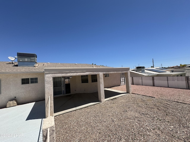 back of house with central air condition unit and a patio area