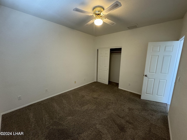 unfurnished bedroom with a closet, ceiling fan, and dark colored carpet