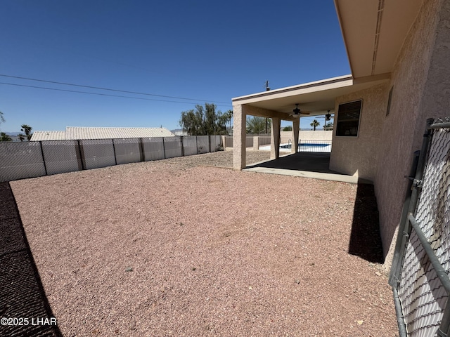 view of yard featuring a patio area and ceiling fan