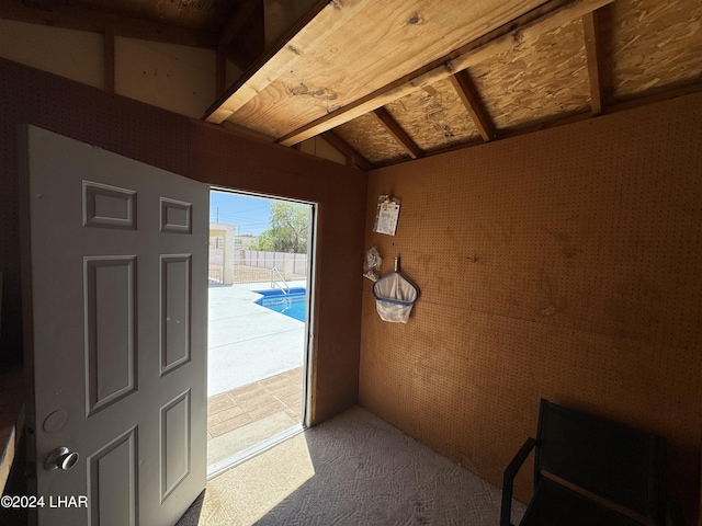 doorway to outside with vaulted ceiling