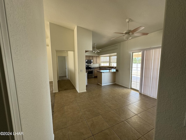 unfurnished living room featuring lofted ceiling, light tile patterned floors, and ceiling fan