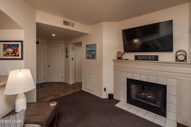 1650 S Smoketree Ave Unit 103, Lake Havasu City, AZ 86403 - carpeted living room featuring a tile fireplace and baseboards