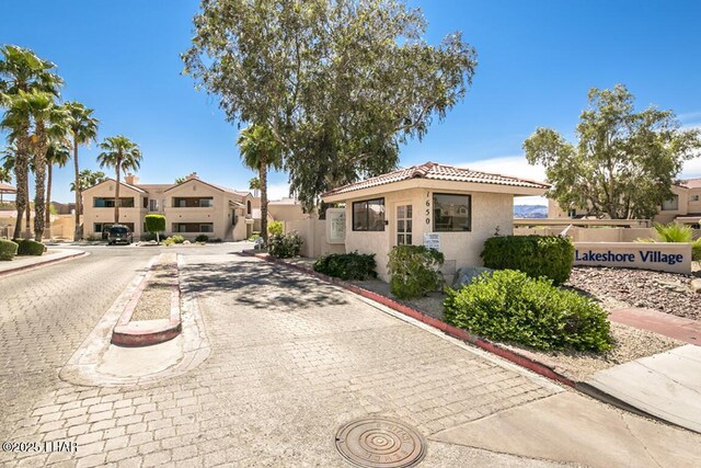 1650 S Smoketree Ave Unit 103, Lake Havasu City, AZ 86403 - view of front facade with stucco siding, a tiled roof, and a residential view