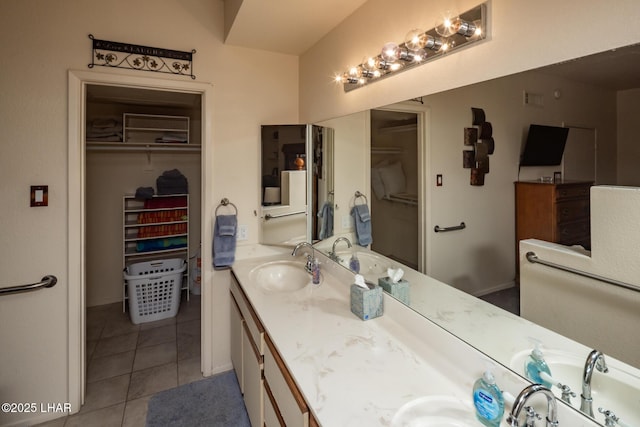 1650 S Smoketree Ave Unit 103, Lake Havasu City, AZ 86403 - bathroom featuring double vanity, tile patterned floors, a spacious closet, and baseboards