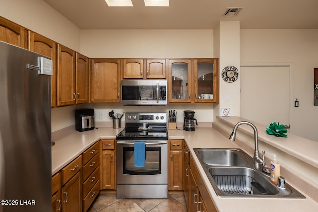 1650 S Smoketree Ave Unit 103, Lake Havasu City, AZ 86403 - kitchen with stainless steel appliances, a sink, brown cabinetry, and light countertops