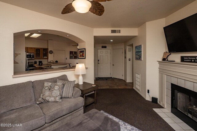 1650 S Smoketree Ave Unit 103, Lake Havasu City, AZ 86403 - carpeted living area with a ceiling fan, arched walkways, and a fireplace