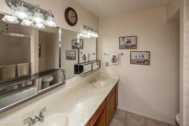 2593 Tradewind Dr, Lake Havasu City, AZ 86403 - full bath with toilet, double vanity, tile patterned flooring, and baseboards