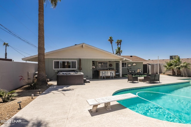 2593 Tradewind Dr, Lake Havasu City, AZ 86403 - view of pool featuring an outdoor hot tub, a patio area, a diving board, and a fenced backyard