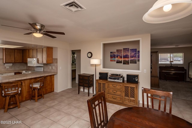 2593 Tradewind Dr, Lake Havasu City, AZ 86403 - dining room with light tile patterned floors and a ceiling fan