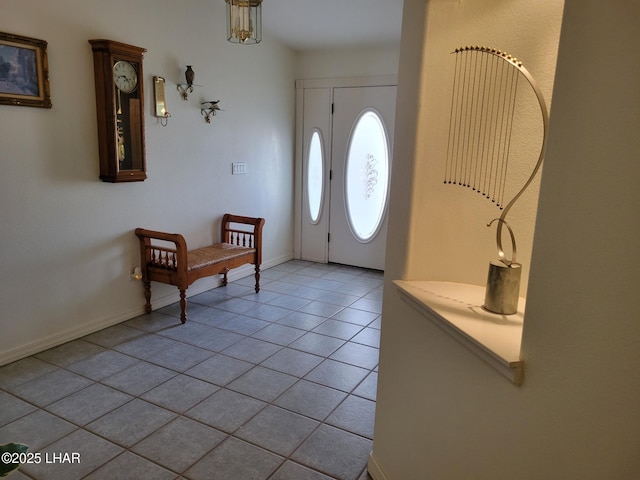 entryway with light tile patterned flooring and baseboards