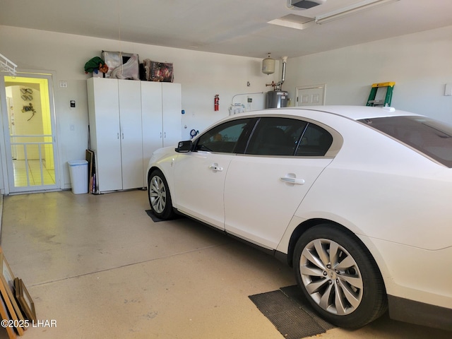 garage with electric water heater and a garage door opener