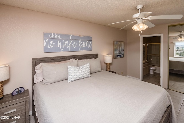 777 Harrah Way Unit 512, Lake Havasu City, AZ 86403 - tiled bedroom featuring connected bathroom, a ceiling fan, and a textured ceiling