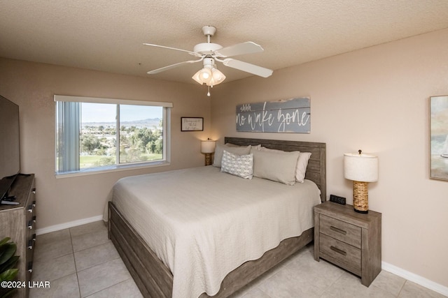 777 Harrah Way Unit 512, Lake Havasu City, AZ 86403 - bedroom featuring baseboards, tile patterned flooring, a ceiling fan, and a textured ceiling