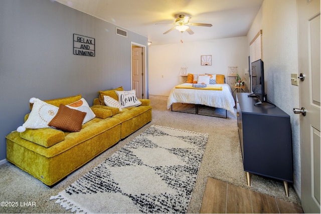 carpeted bedroom with visible vents and ceiling fan